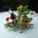 Grouping of Flowers on Large Square Table in rear dining area